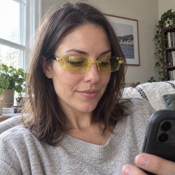 Yellow tint smart zoom reading glasses while using phone