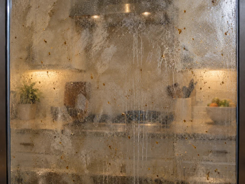 Before cleaning cloudy oven glass with grease spots