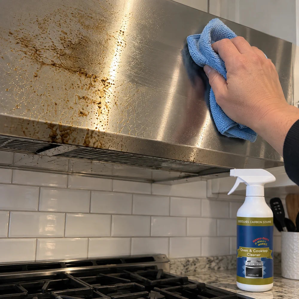 Customer wiping greasy stainless range hood with blue cloth