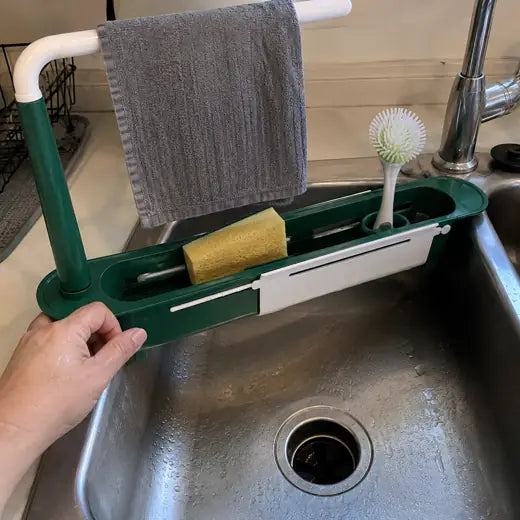 Telescopic sink rack being adjusted by hand