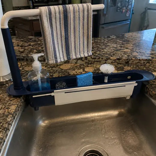 Blue sink rack organized with soap bottle sponge and towel