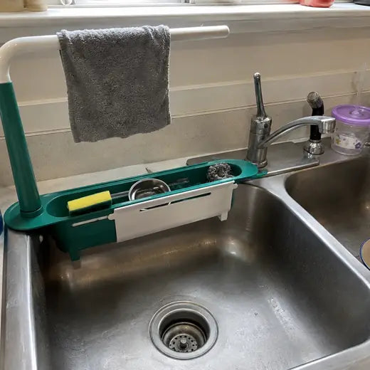 Green sink caddy stretched across a double sink