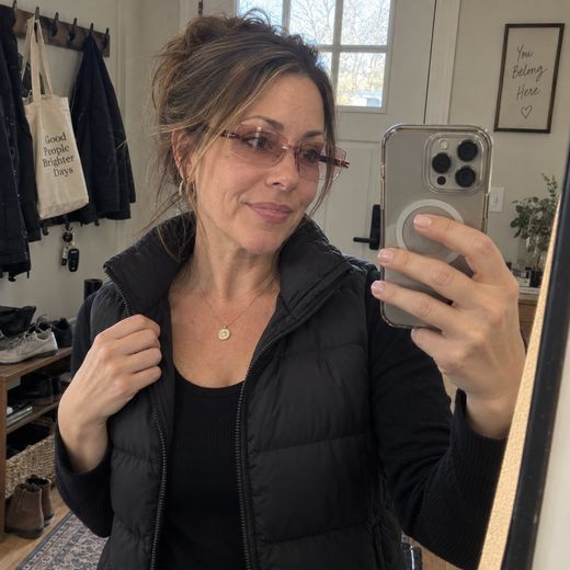 Woman taking mirror selfie with rose smart zoom glasses