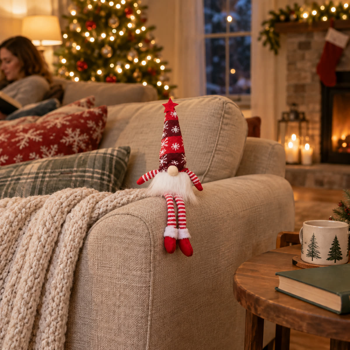 Red Christmas long leg doll sitting on a sofa arm in a warm holiday living room